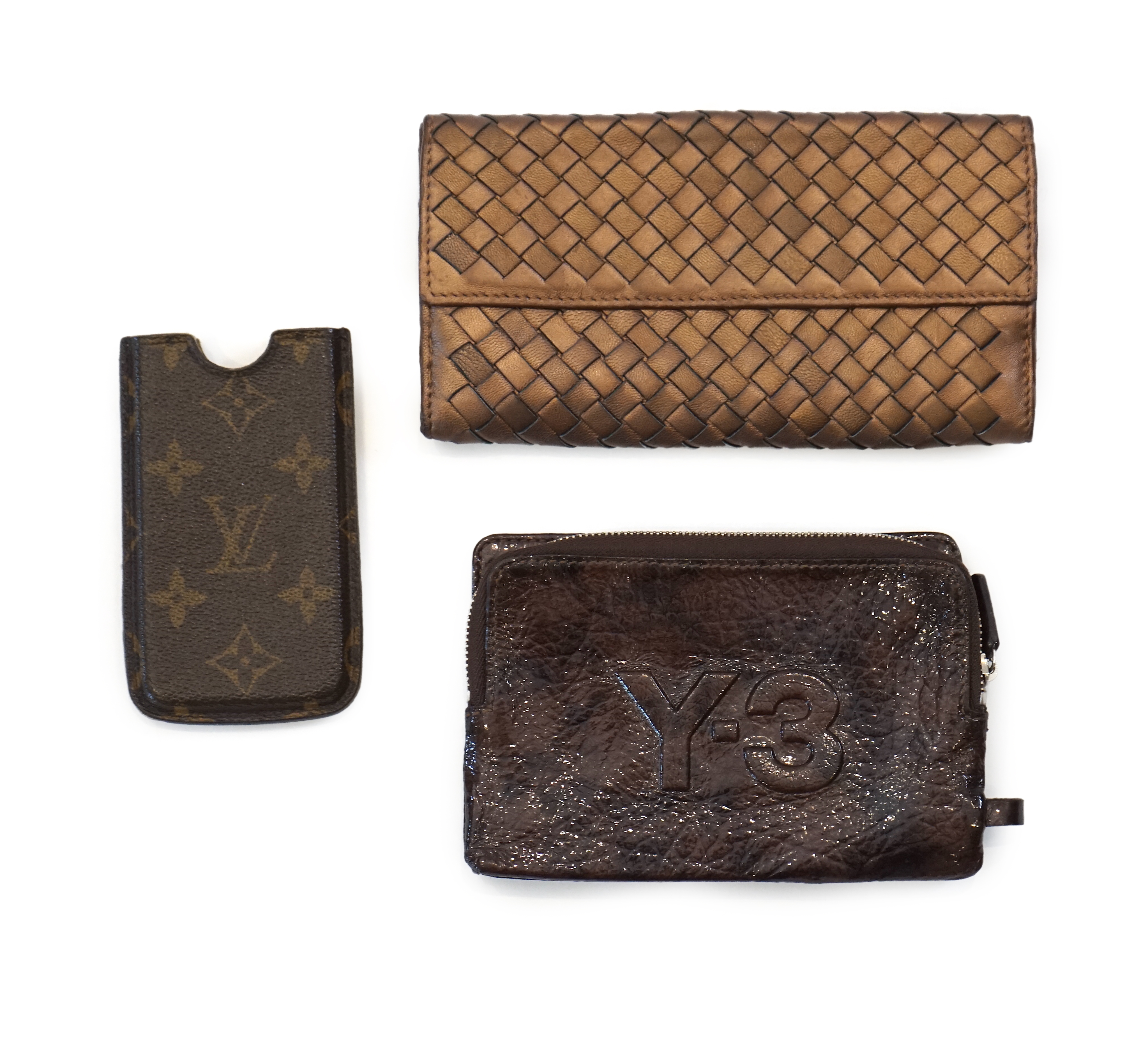 A Bottega Veneta purse, a Y-3 purse/wallet and a Louis Vuitton phone case